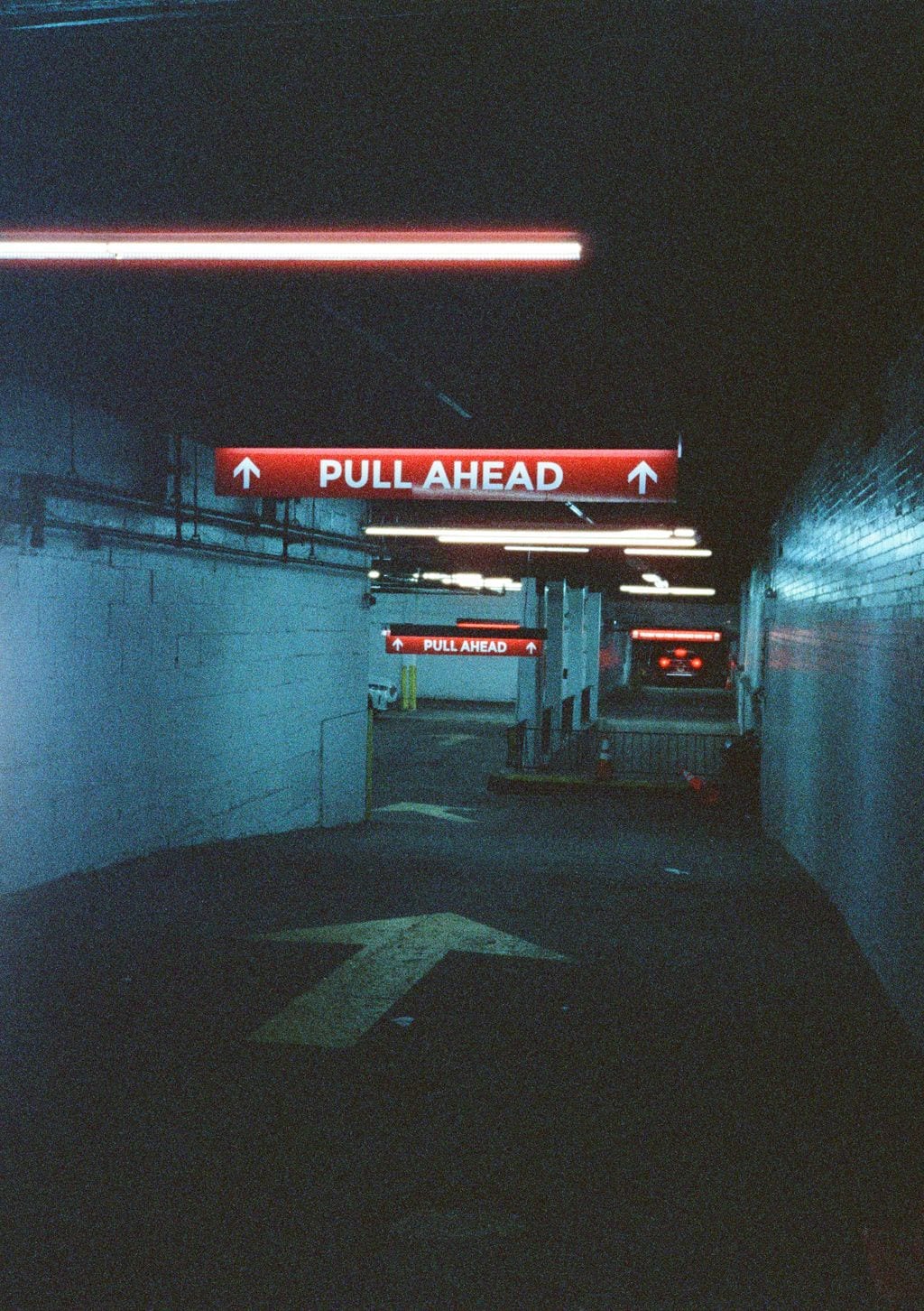 “Pull Ahead” neon in a parking garage — 35mm