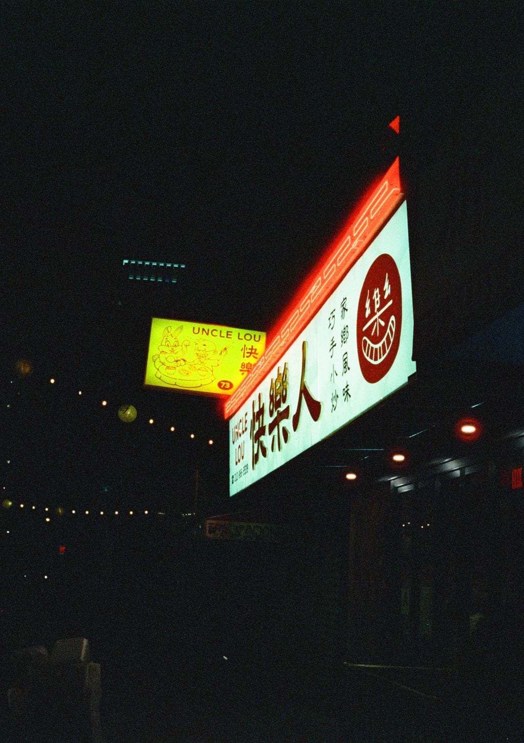 Uncle Lou neon sign, Chinatown at night — 35mm
